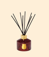 Diffuseur de parfum Trudon Cire en verre rouge avec bâtons en rotin pour la maison