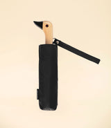 black umbrella by Original Duckhead. Duck head wooden handle. Closed with pocket.